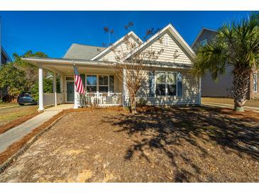 Charming one-story home with front porch and American flag at 104 Pavilion St, Summerville, SC 29483