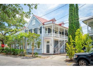 Charming two-story home with a metal roof and a wrap-around porch at 27 Chapel St, Charleston, SC 29403