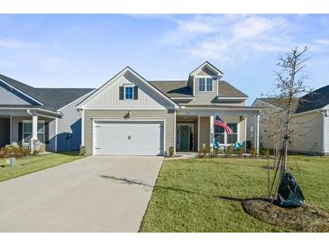 Two-story craftsman style home with a two car garage and landscaped lawn at 274 Tupelo Lake Dr, Summerville, SC 29486
