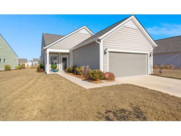 Gray house with attached garage and landscaped front yard at 487 Switchgrass Dr, Summerville, SC 29486
