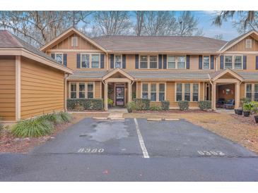 Tan two-story home with black shutters and parking at 8382 Camp Gregg Ln, North Charleston, SC 29418