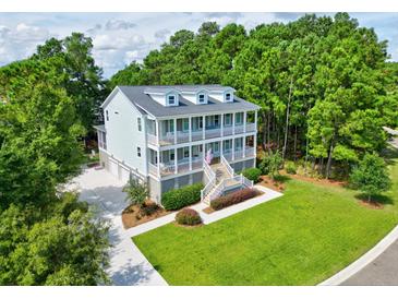 Two-story house with large backyard and driveway, surrounded by lush green trees at 1504 Rivertowne Country Club Dr, Mount Pleasant, SC 29466