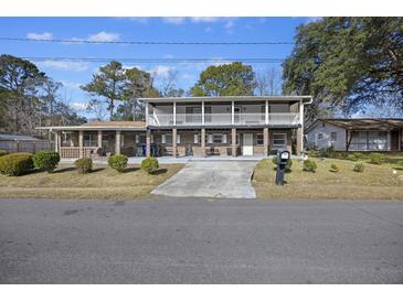 Two-story house with a large front porch and driveway at 1520 Acacia St, Charleston, SC 29407