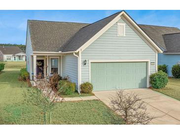 Charming one-story home with light blue siding, attached garage, and landscaped yard at 310 Bloomington Way, Summerville, SC 29486