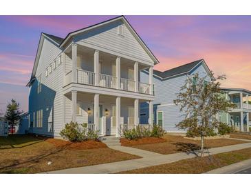 Two-story white house with front porch, landscaping, and sidewalk at 507 N Commodore Way, Summerville, SC 29483