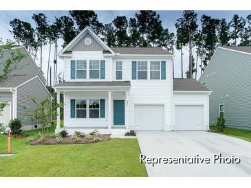 Two-story house with white siding, teal door, and two-car garage at 1015 Marsh Harrier Dr # Cc3-3-2, Ravenel, SC 29470