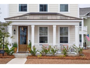 Two-story home with a charming front porch and metal roof at 1245 Crooked Oak Rd, Charleston, SC 29492