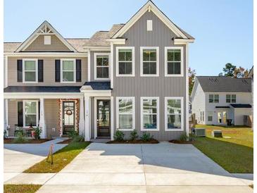 Two-story townhome with gray siding, front porch, and driveway at 211 Abercom Place Dr, Moncks Corner, SC 29461