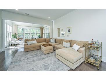 Spacious living room with large sectional sofa and sunroom access at 2910 Clearwater Dr, Mount Pleasant, SC 29466