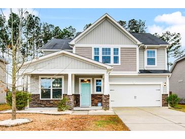 Two-story house with light gray siding, stone accents, and a two-car garage at 339 Spectrum Rd, Summerville, SC 29486