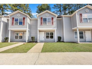 Three-unit townhome building with gray siding and red shutters at 519 Travelers Blvd, Summerville, SC 29485