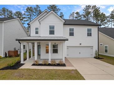 Two-story white house with gray roof, front porch, and attached garage at 530 Richfield Way, Summerville, SC 29486