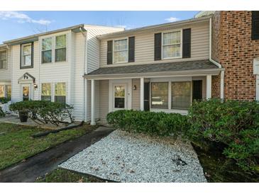 Two-story townhome with a covered porch and well-maintained landscaping at 1101 Reserve Way, Summerville, SC 29485