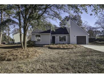 Newly renovated gray house with a landscaped yard and driveway at 117 Hummingbird Ave, Ladson, SC 29456