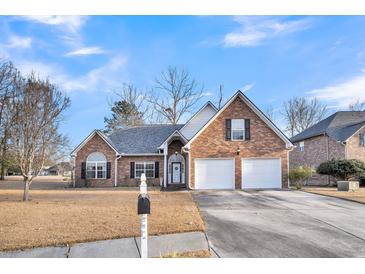 Brick house with two-car garage and well-maintained lawn at 145 Dasharon Ln, Goose Creek, SC 29445