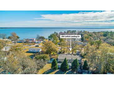 Aerial view of waterfront home with surrounding houses and trees at 208 Catfish Landing Cir, Bonneau, SC 29431