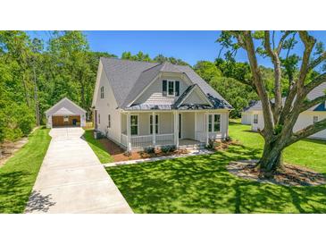 Craftsman style home with front porch, detached garage, and mature landscaping at 2841 Auldreeke Rd, Johns Island, SC 29455