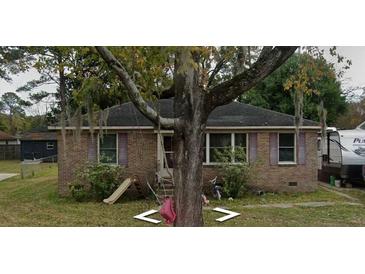 Brick ranch home with mature landscaping and a spacious yard at 310 Adeline Dr, Goose Creek, SC 29445