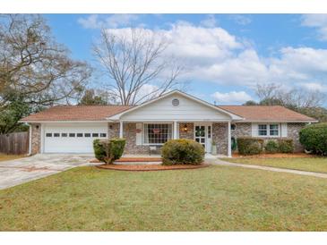 Brick ranch house with attached garage, landscaping, and a well-maintained lawn at 4334 Bream Rd, North Charleston, SC 29418