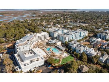 Aerial view of a resort community with pools, lush landscaping, and various buildings at 5804 Palmetto Dr # A-201/203, Isle of Palms, SC 29451