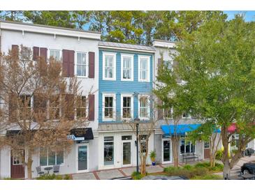 Three-story building with blue and white siding, multiple storefronts, and ample parking at 712 S Shelmore Blvd # 15, Mount Pleasant, SC 29464