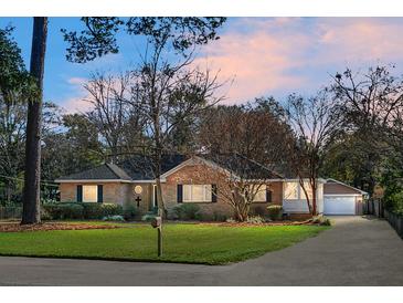 Brick ranch home with landscaped yard, driveway, and detached garage at 917 S Main St, Summerville, SC 29483