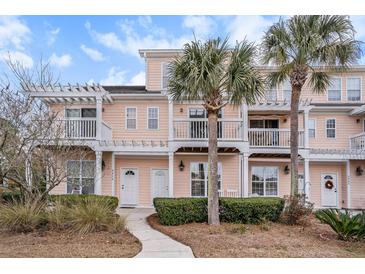 Three-story peach building with white trim, balconies, and palm trees at 2978 Sugarberry Ln, Johns Island, SC 29455