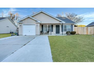 Tan house with a white garage door and black shutters at 124 Pointer Dr, Goose Creek, SC 29445