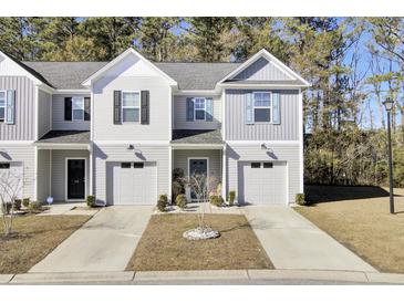 Two-story townhome with gray siding, attached garage, and landscaping at 128 Buchanan Cir, Goose Creek, SC 29445
