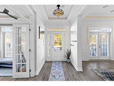 Bright and airy entryway with hardwood floors, french doors, and a view to the backyard at 1493 Nautical Chart Dr, Charleston, SC 29414