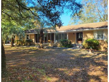 Ranch-style brick home nestled on a spacious lot with mature trees at 400 Murray Blvd, Summerville, SC 29483