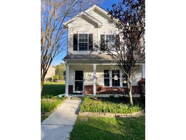 Two-story house with a brick and siding exterior, front porch, and landscaped yard at 406 Chinquapin Dr, Summerville, SC 29485
