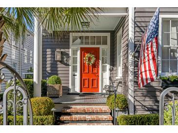 Inviting front door with a wreath and brick steps at 70 Warren St, Charleston, SC 29403