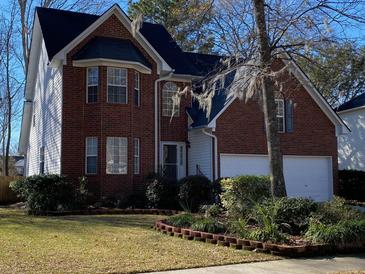 Brick two-story house with a two-car garage and landscaped lawn at 127 Spalding Cir, Goose Creek, SC 29445