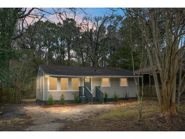 Charming bungalow with gray siding, well-manicured lawn, and inviting front porch at 2334 Falcon Rd, North Charleston, SC 29406
