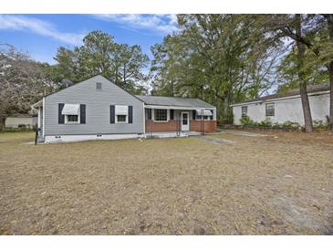 Ranch style home with gray siding, brick accents, and a spacious yard at 2736 Bonds Ave, North Charleston, SC 29405