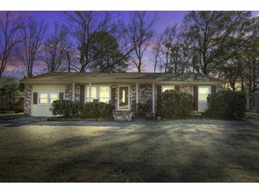 Brick ranch house with a well-manicured lawn at 303 Holly Avenue Ave, Goose Creek, SC 29445