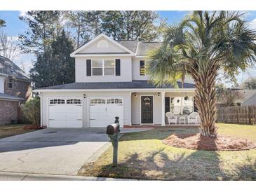 Two-story house with two-car garage, palm tree, and inviting front porch at 5463 Altamaha Dr, North Charleston, SC 29420