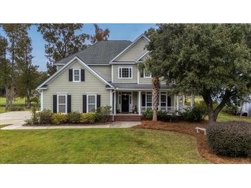 Two-story house with a large front porch and well-maintained lawn at 113 History Ln, Summerville, SC 29485