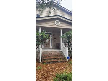 Two-story house with front porch and steps at 1150 King St, Charleston, SC 29403