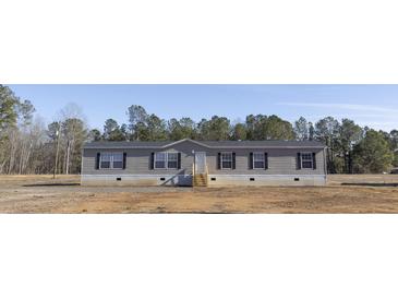 Newly constructed manufactured home with gray siding and black shutters at 120 Wilder Rd, Saint Stephen, SC 29479