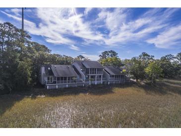 Aerial view of charming waterfront property with multiple units and marsh views at 1248 Creek Watch Trce, Seabrook Island, SC 29455