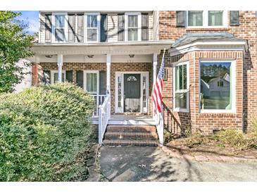 Brick home with a front porch and American flag at 151 Belleplaine Dr, Goose Creek, SC 29445