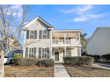 Two-story house with front porch, landscaping, and a walkway at 1724 Bee Balm Rd, Johns Island, SC 29455