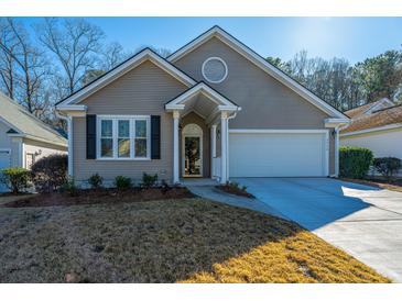 Craftsman style home with attached garage and manicured lawn at 2426 Tuscany Dr, North Charleston, SC 29406