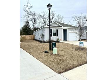 Gray house with white garage door, and landscaping at 350 Feldspar Ln, Ladson, SC 29456