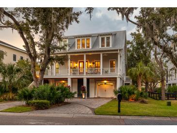 Two story home with gray siding, large front porch, and two car garage at 1860 Headquarters Plantation Dr, Johns Island, SC 29455