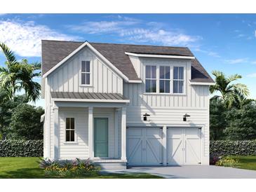 Charming farmhouse exterior with two-car garage and landscaped yard at 358 Trailmore Ln, Summerville, SC 29486