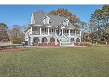 Two story home with wrap around porch and spacious yard at 3980 River Rd, Johns Island, SC 29455