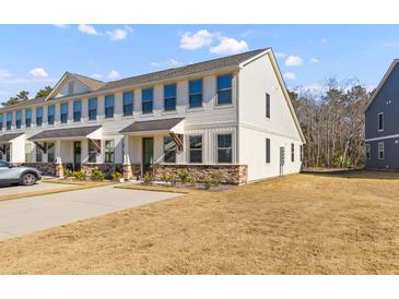 Two-story townhome with stone accents and a metal roof at 5100 Park Creek Ave, North Charleston, SC 29418